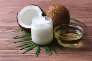 close up of cut open coconut and coconut oil