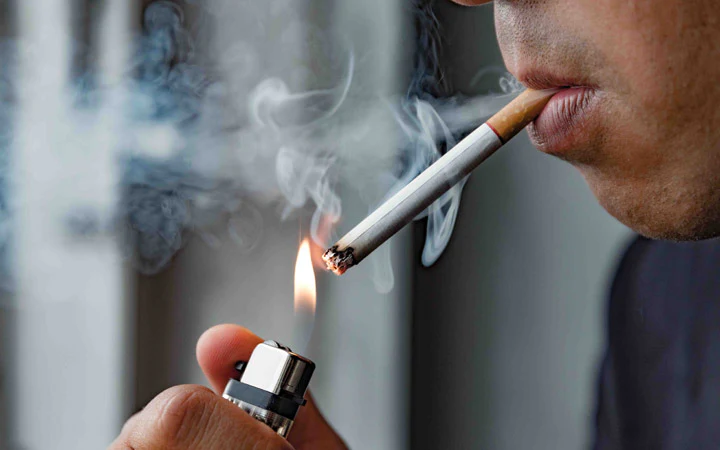 man smoking showing the relationship between smoking and hair loss