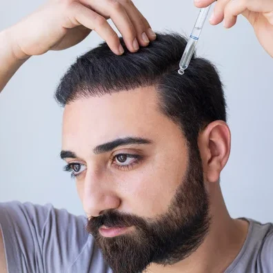 man applying minoxidil FAQs