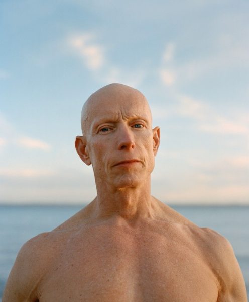 shirtless man with alopecia universalis